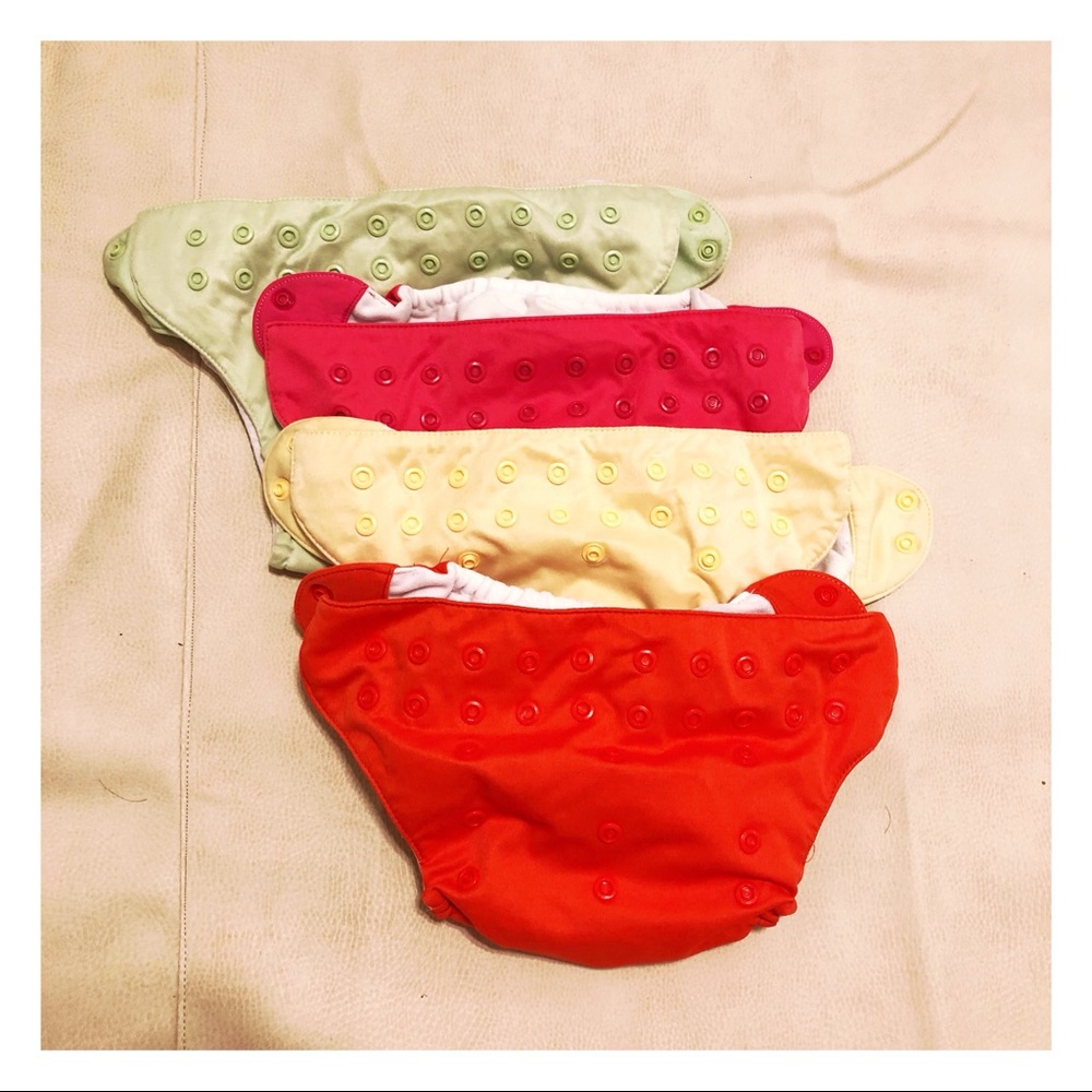 Four bumGenius one size pocket cloth diapers